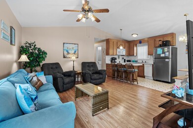 Living room with light hardwood / wood-style floor