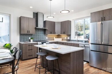 Chef's Kitchen with Stainless Steel Appliances and Tile Backsplash