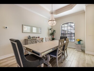 Dining area with tray ceiling and crown molding.