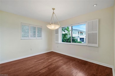 Empty room featuring baseboards and wood finished floors
