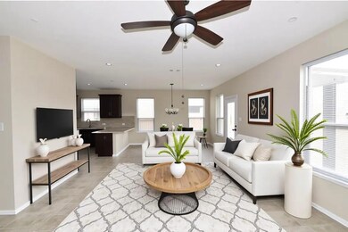 Living area with a ceiling fan, baseboards, light