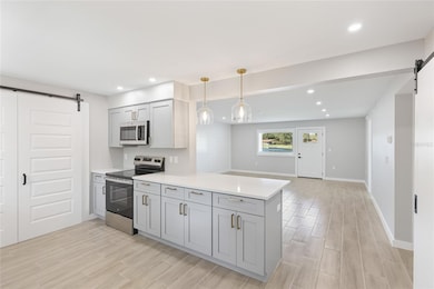 Kitchen looking on to the living room & back door to the patio
