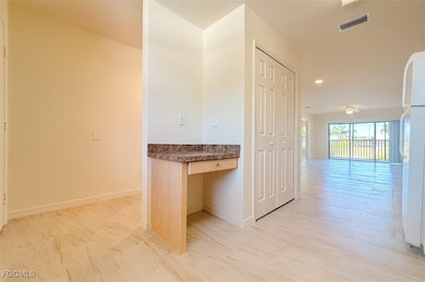 Hallway featuring a desk and recessed lighting