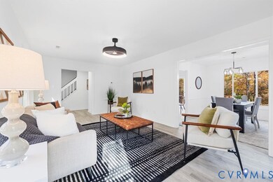 Living room with light wood-style floors and a chandelier