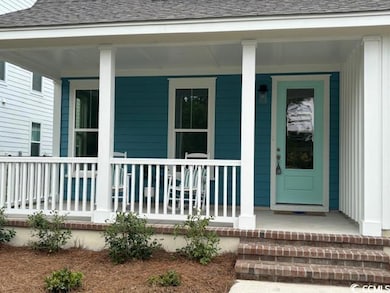 Entrance to property featuring a shingled roof and