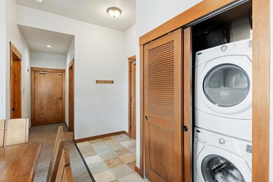 Washroom featuring stacked washer and clothes drye