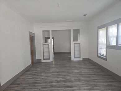 Empty room featuring crown molding, french doors, 