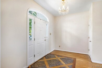 Elegant entry foyer with slate/wood floor design and exquisite light fixture from the Czech Republic