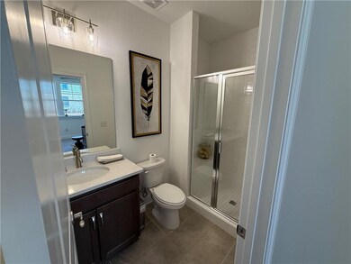 Full bath featuring tile patterned floors, toilet,