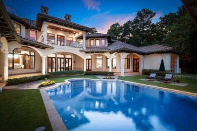 Variable depth lighted pool with wide steps, fountains, negative edge tiled spillway fountain from elevated spa into pool.