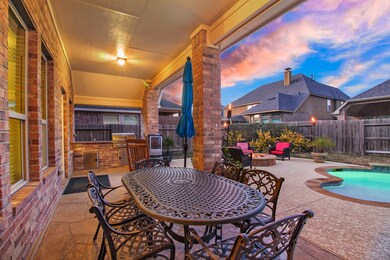 Texas size covered patio with an outdoor kitchen!