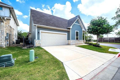 View of front of home featuring stone siding, dri