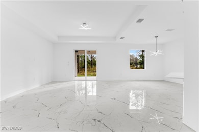 Empty room featuring a tray ceiling