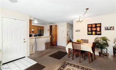 Dining area featuring carpet and a chandelier