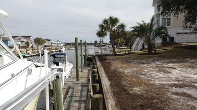 On dock, owner boat to left