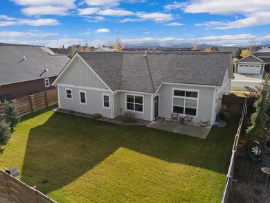 Back of property with a fenced backyard and a patio area.