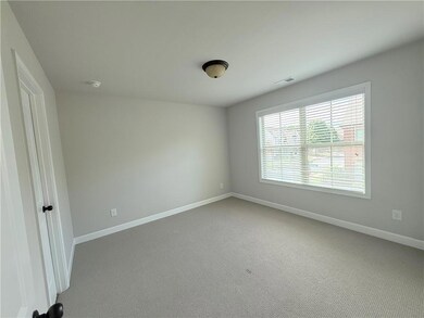 Carpeted spare room with baseboards
