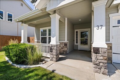 Doorway to property featuring covered porch and stone siding