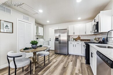 Kitchen with light hardwood / wood-style floors, t