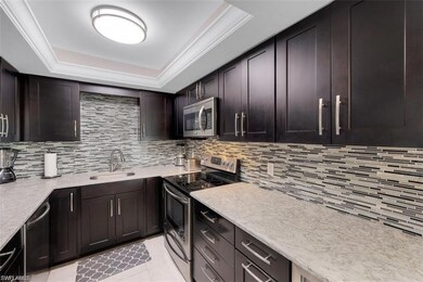 Kitchen with a sink, a raised ceiling, decorative 