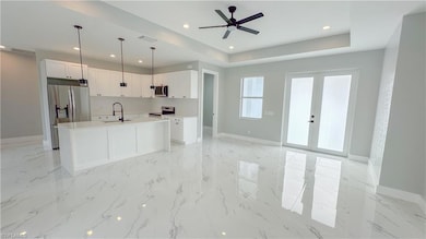 Model Home Kitchen with white cabinets, a center i