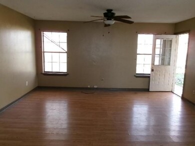Empty room with a ceiling fan, wood finished floor