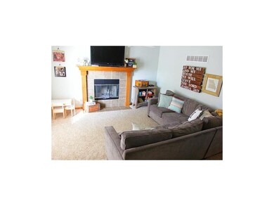Fireplace and new carpet in welcoming living room