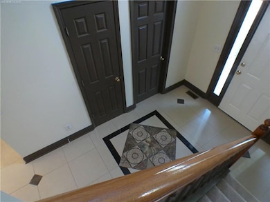 Entryway featuring light tile patterned floors and baseboards