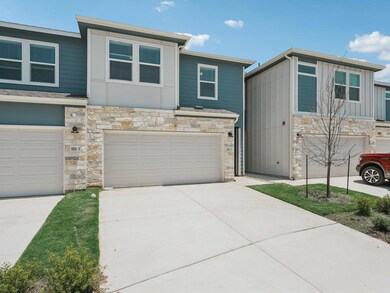 View of front of home with stone siding, a garage