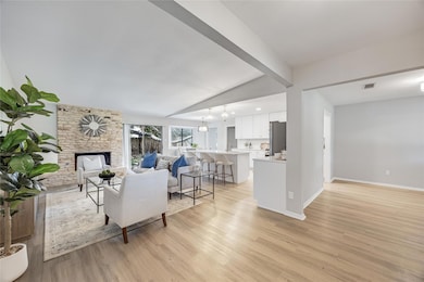 Living room with light wood-type flooring and a s