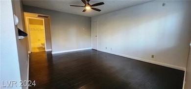 Unfurnished room featuring dark wood finished floo