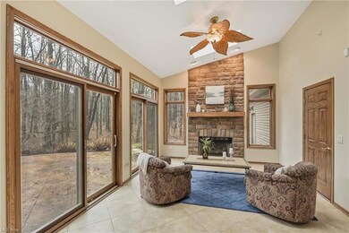 Cozy family room with gas fireplace connects outdo