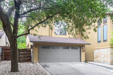View of front of home with stucco siding, a garag