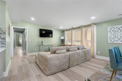 Living room featuring recessed lighting, light woo