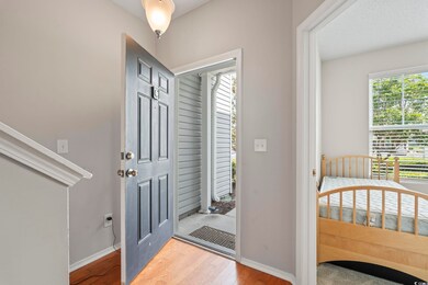 Foyer entrance with healthy amount of natural light, wood finished floors, and baseboards