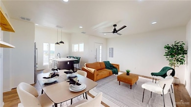 Living room featuring visible vents, ceiling fan, recessed lighting, and light wood-style floors