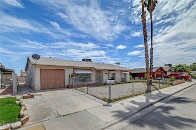 Ranch-style home with an attached garage, concrete