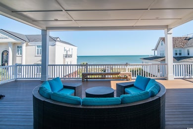 Wooden deck with outdoor lounge area and a water view
