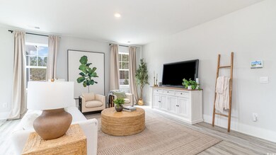 Living area with baseboards, light wood-style flooring, and recessed lighting