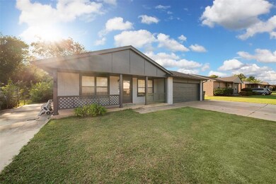 2 car garage with extended driveway plus additional concrete drive on the opposite side of the home providing ample parking for vehicles, boat, or RV