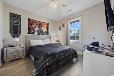 Bedroom featuring wood finished floors and a ceiling fan