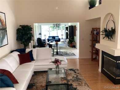 Living room w/wood fireplace, open and high ceilin