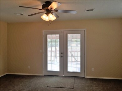 Large living area with French doors to back deck.