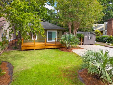Exterior space with a front lawn, a shed, and a de