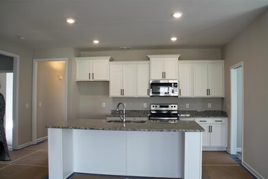 The spacious kitchen island in a similar house. 