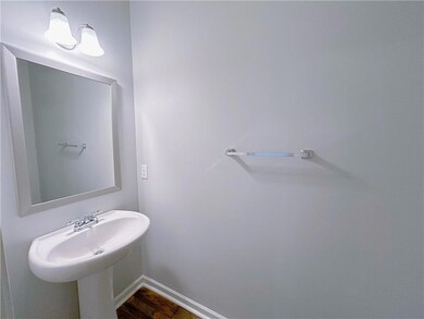 Bathroom with baseboards and wood finished floors