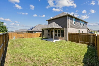 A spacious backyard with well-maintained grass and