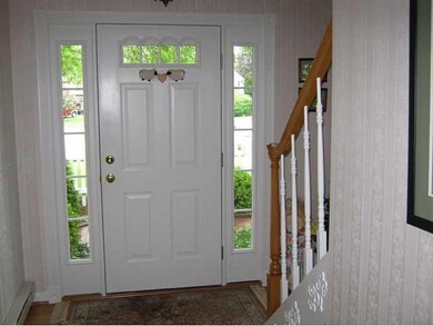 Other. View of Foyer - Sidelights surround entry door - Hardwood Floors & Solid Oak Stairs with Birch Railing.