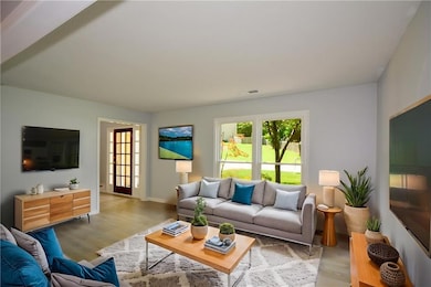 VS Living area with light wood-type flooring and baseboards