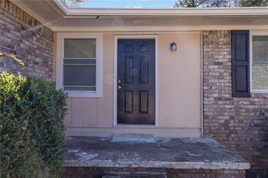 View of exterior entry with brick siding